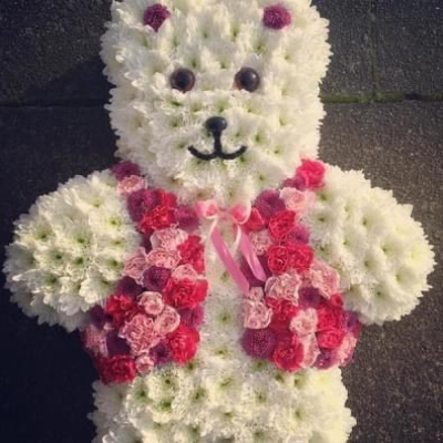 Teddy with pink Jacket - A funeral tribute in the shape of a teddy bear. 

Colours of the jacket can be changed.