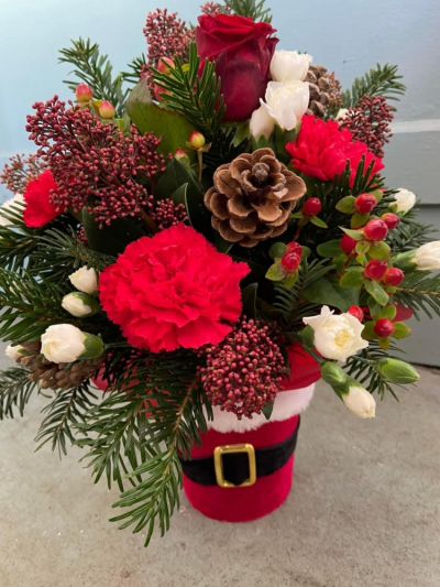 Santa Baby - A festive arrangement in a cute santa themed pot. Filled with fresh seasonal flowers and foliage.