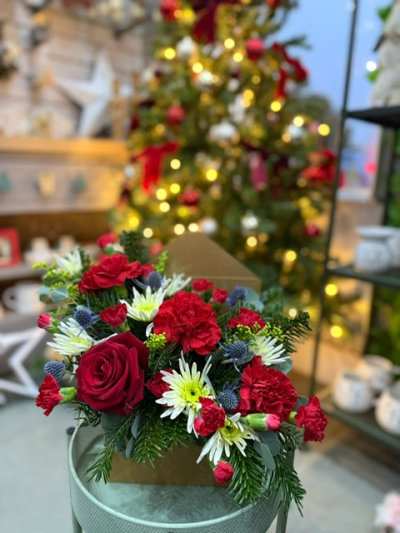 Letter to Santa (Red) - Send festive cheer straight to the heart with Letter to Santa (Red). A charming envelope-style arrangement filled with vibrant red blooms, fresh greenery, and seasonal accents. The perfect way to share Christmas joy in a truly unique design.