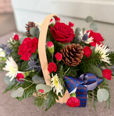 Basket Of Joy - This collection of beautiful flowers and seasonal foliage are expertly arranged in a beautiful basket for the perfect Christmas gift.