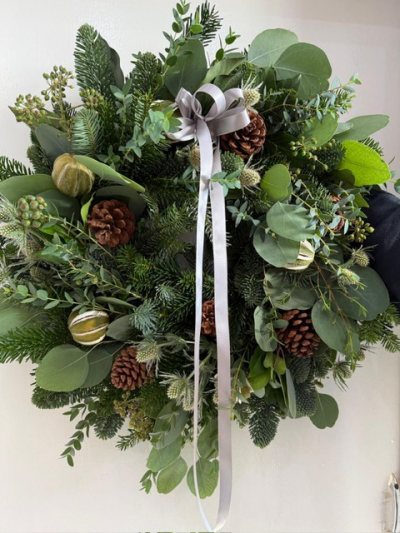 'The Polar Express' Luxury Door Wreath - A luxurious spruce wreath with berried ivy and eucalyptus. Decorated with whole limes, fresh white thistle and pine cones - finished off with a silver satin ribbon. Handmade by us at The Flower Cabin.