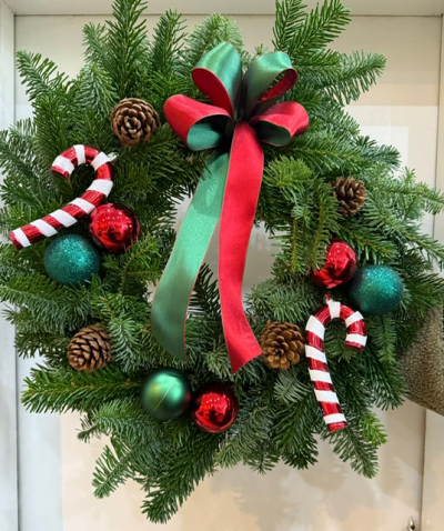 'Elf' Traditional Door Wreath - A traditional spruce wreath decorated with red and green baubles, pine cones and candy canes - finished off with a red and green bow.