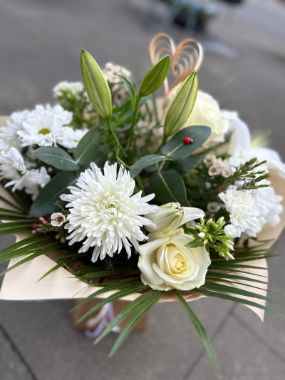 Vanilla Latte - A classic mixture of white seasonal blooms hand tied with mixed foliage. Wrapped in cellophane and presented in a water box.